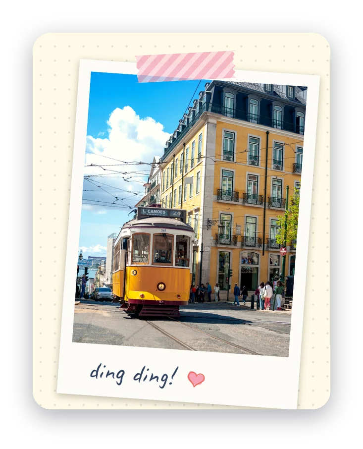A photo of a yellow Lisbon tram taped to a journal page with pink striped sticker tape